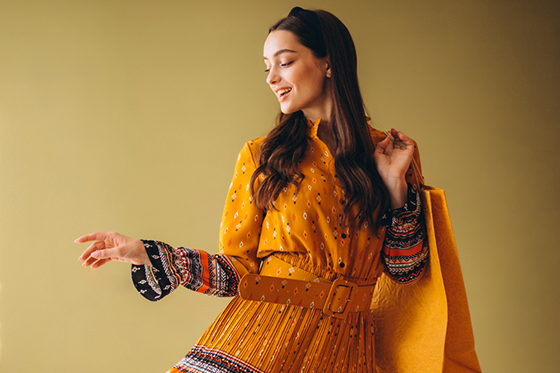 SUVETTE model wearing an orange patterned dress.
