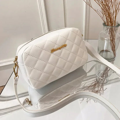 SUVETTE white quilted crossbody bag on glass table