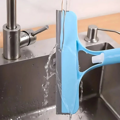 SUVETTE blue spray squeegee being rinsed under a tap