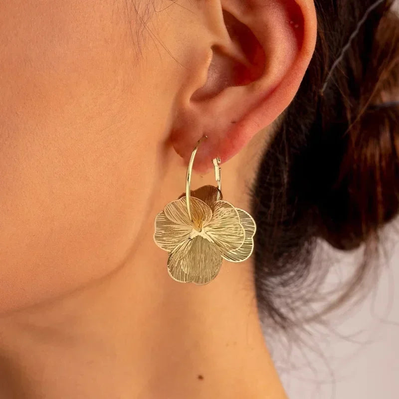 SUVETTE gold flower hoop earrings worn
