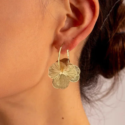 SUVETTE gold flower hoop earrings worn