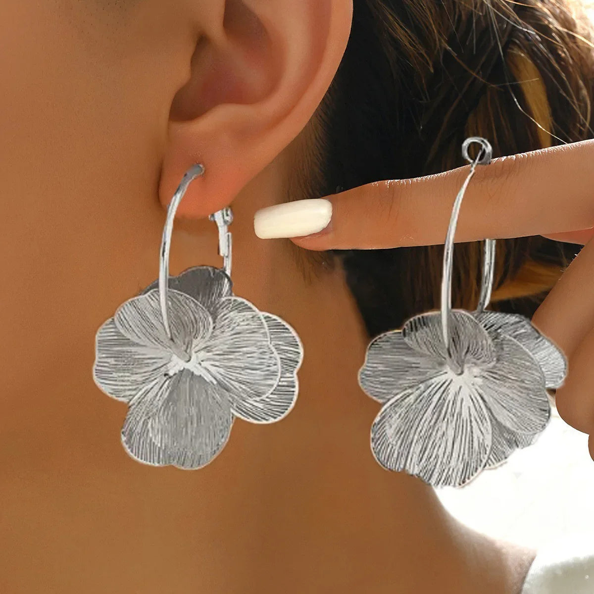 SUVETTE silver flower hoop earrings worn