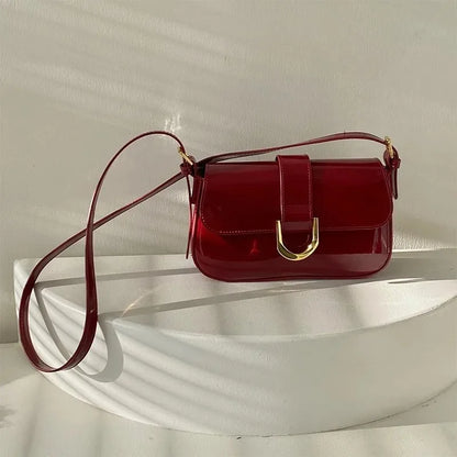 SUVETTE red horseshoe buckle crossbody bag flat lay